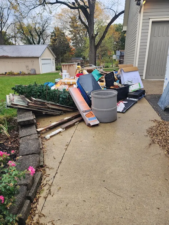 Dumpster being loaded with debris for Estate Cleanout Dumpster Rental in Chinle